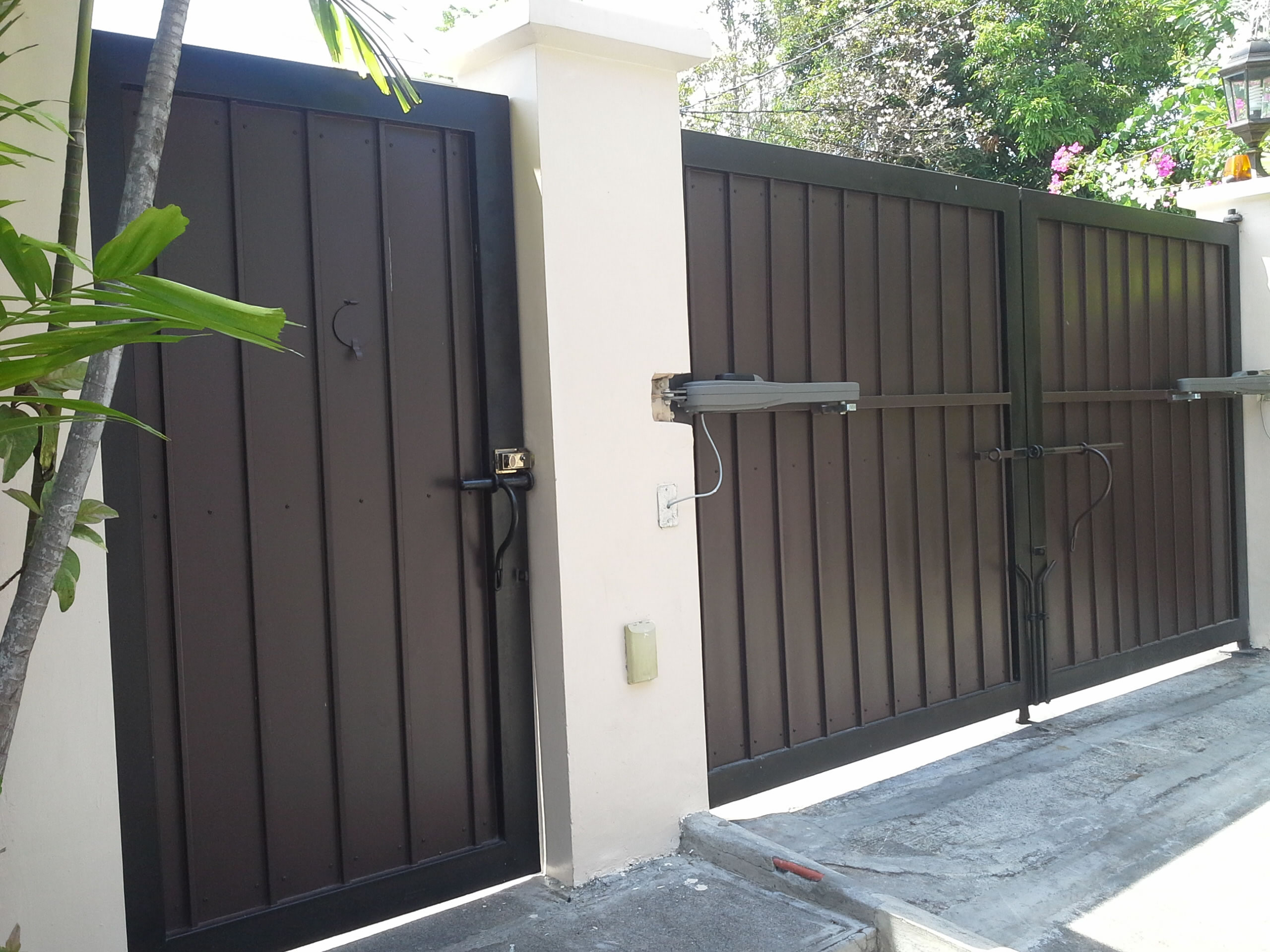Gate in wood finish and wrought iron frame and studs accent.