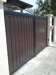 Gate in wood finish and wrought iron frame and studs accent.